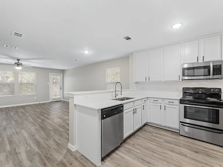 Kitchen with Stainless Steel Appliances - Renovated Home