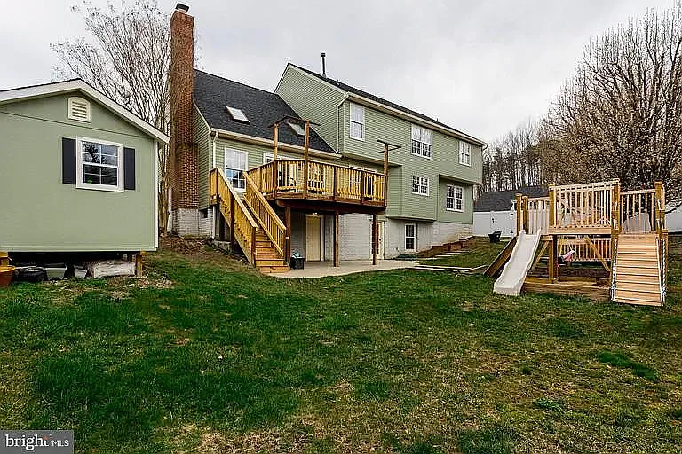 Deck has been stained white, the building to the left is an outdoor shed with LOTS of storage. The playground on the right has been replaced with a newly installed firepit & chairs, there is a LOT of firewood behind the shed PLEASE USE