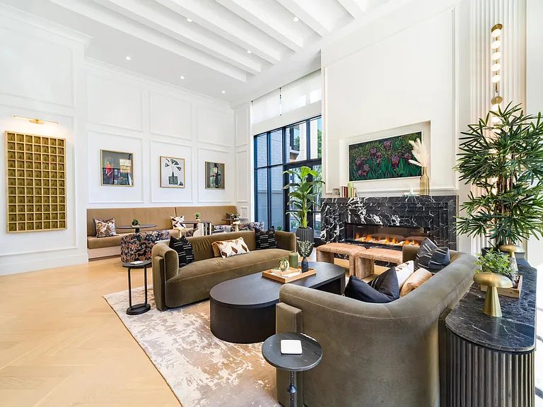 Resident lounge with layered seating, a statement fireplace, and curated finishes creating a comfortable space for conversation and everyday gathering.
