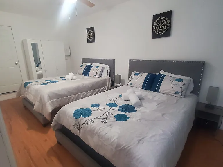 Comfortable rooms with queen-size beds, lighting, ceiling fans, and decorative paintings