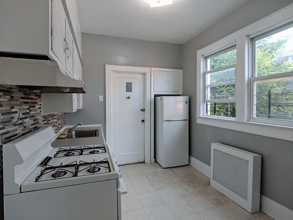 Entrance to the apartment, large window, and kitchen and dining combo.