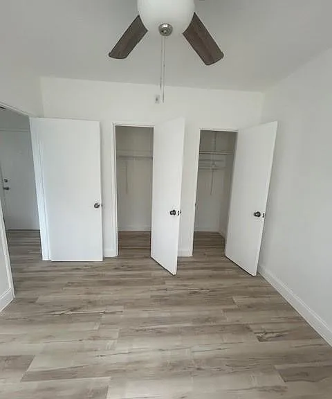 bedroom closets and amazing wood plank flooring - designer baseboards