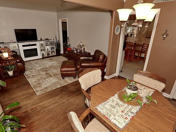 View from dining room towards living room w/electric fireplace and built-ins