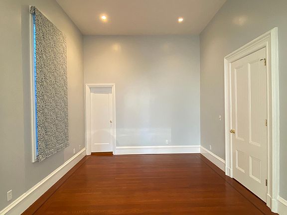 Bedroom 1 with half bath door at back of room.