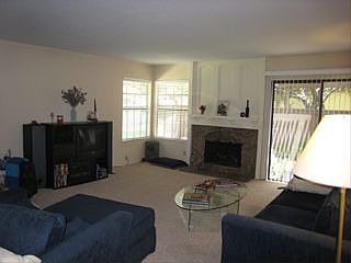 Living room with fireplace and sliding glass doors to patio