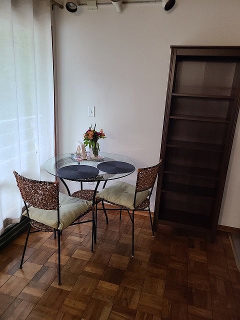 Open dining area with large picture window and parquet wood flooring