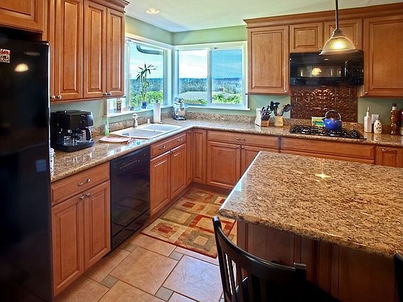 Maple cabinets, granite slab counters, and GE appliances.