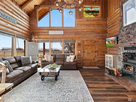 The floor to ceiling fireplace/stove surround is a grand feature in the great room that is rivaled only by the views of the surrounding property. Newer wood stove supplements the forced air furnace which all keeps the home toasty warm.