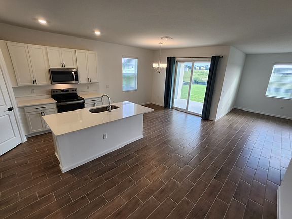 Open kitchen floorplan, overlooking dining and living rooms.