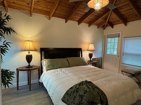 Tropical Primary Bedroom w/ Olympic Queen Bed & private 8x10 deck access.