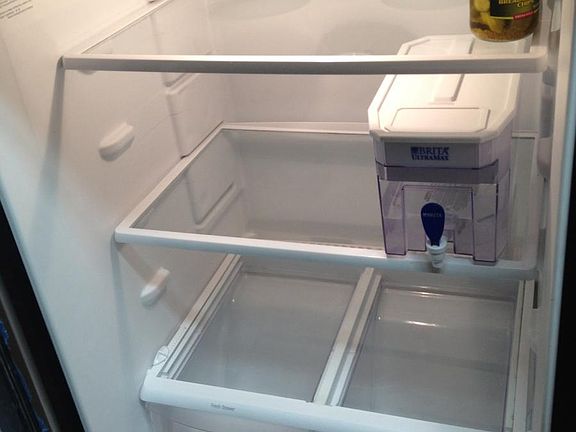 This apartment had a tenant who renewed so we put his water and pickles back in the fridge after cleaning for new roommates.