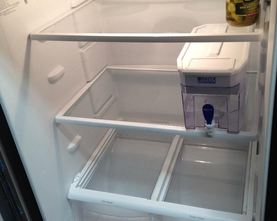 This apartment had a tenant who renewed so we put his water and pickles back in the fridge after cleaning for new roommates.