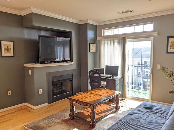 Living room with fireplace and balcony
