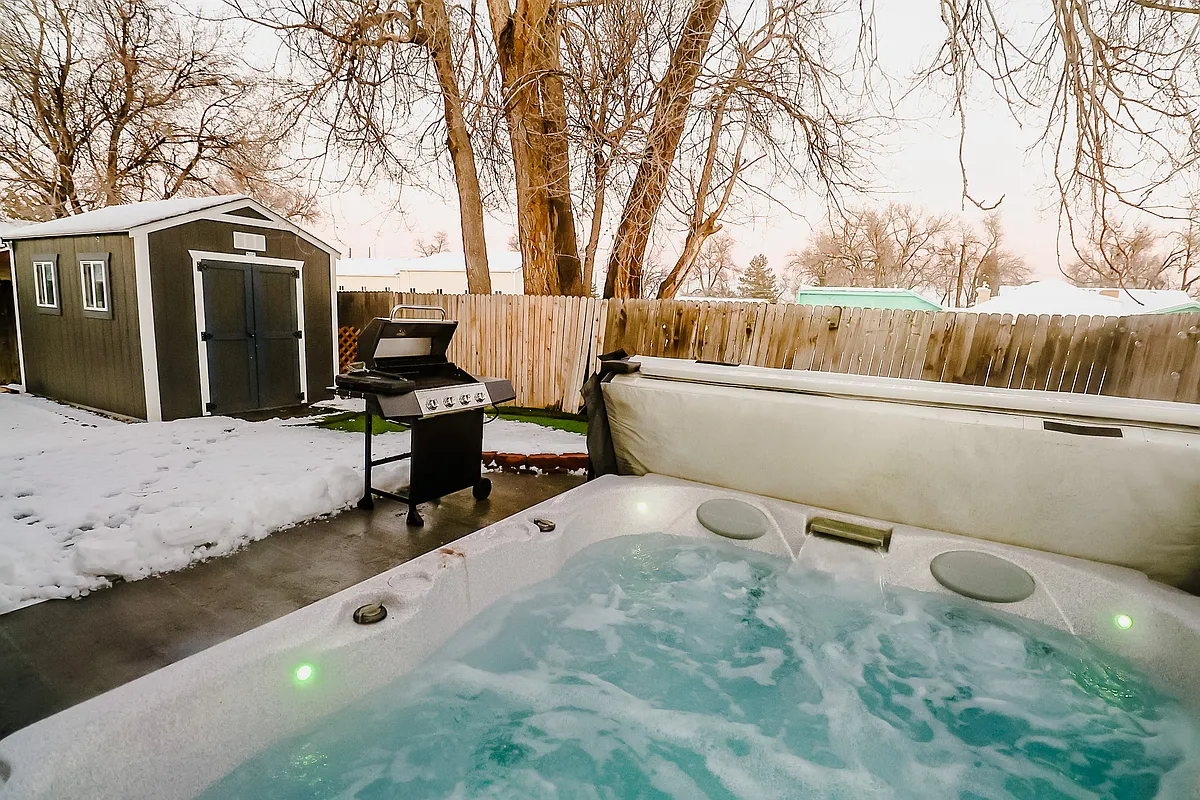 An inviting outdoor retreat boasting both a soothing Jacuzzi and a modern BBQ grill, perfect for relaxation and entertaining under the open sky - 4350 Xenon St