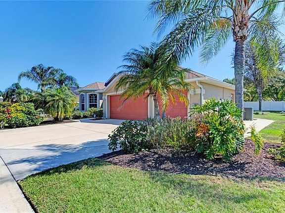 right front and right side of property with Queen & Pygmy palms & landscaping