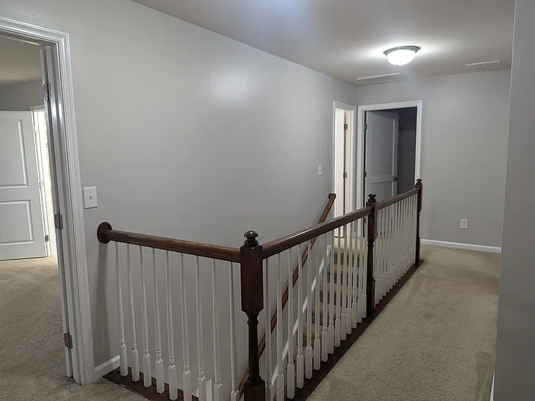 Upstairs hallway. Laundry room and hall bathroom in back left.