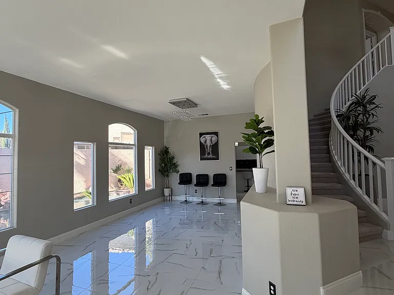 Spacious entry-adjacent area with an open layout, ideal for a planned shuffleboard and additional recreational use.