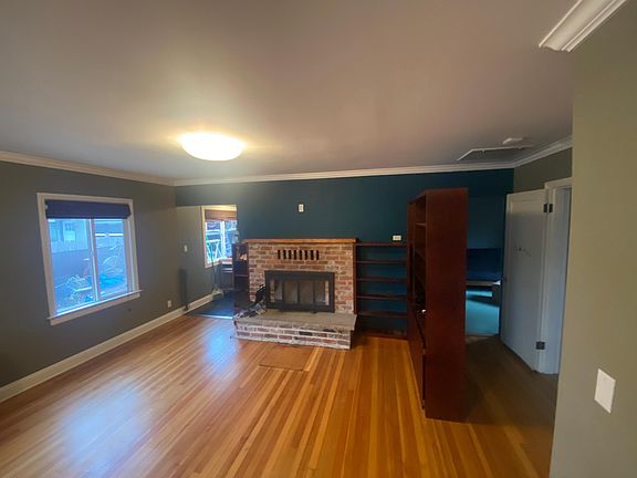 Main living area, fireplace, and built-in bookshelves.