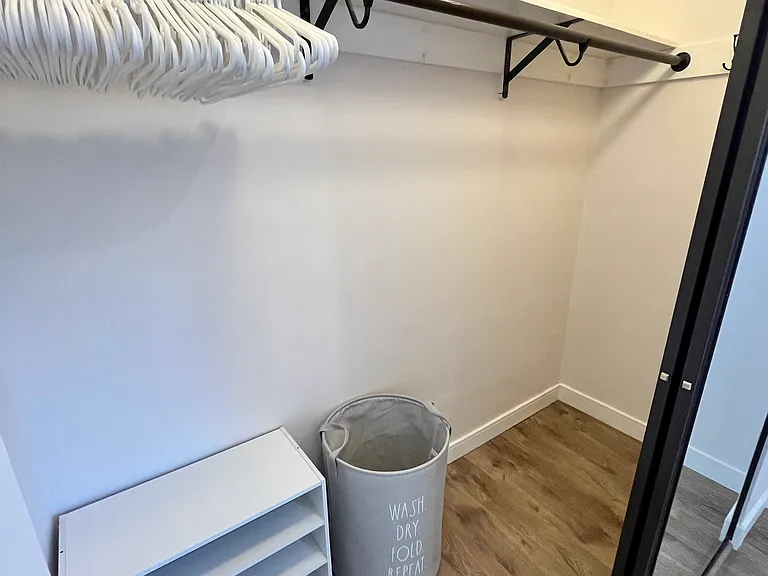 Bedroom closet 90.5"w x 33"d x 98"h with interior light.
Hangers, hooks, shoe storage, shelf storage and laundry basket.