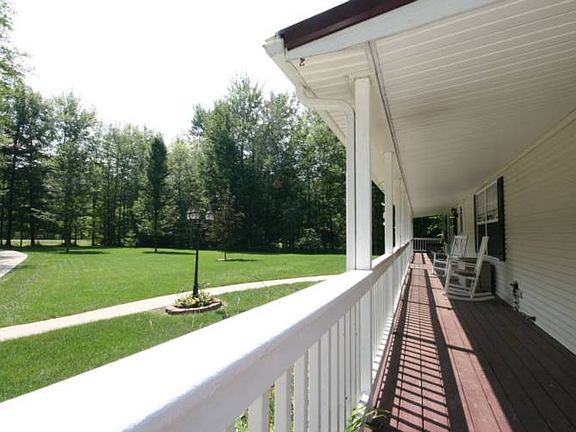 Another picture of the length of the porch and the front of the property from the view of the home.