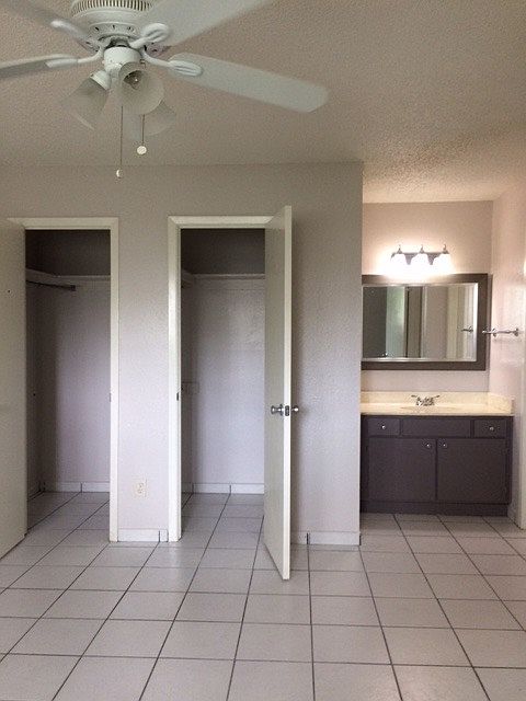 Bedroom with walk-in closet & vanity/sink