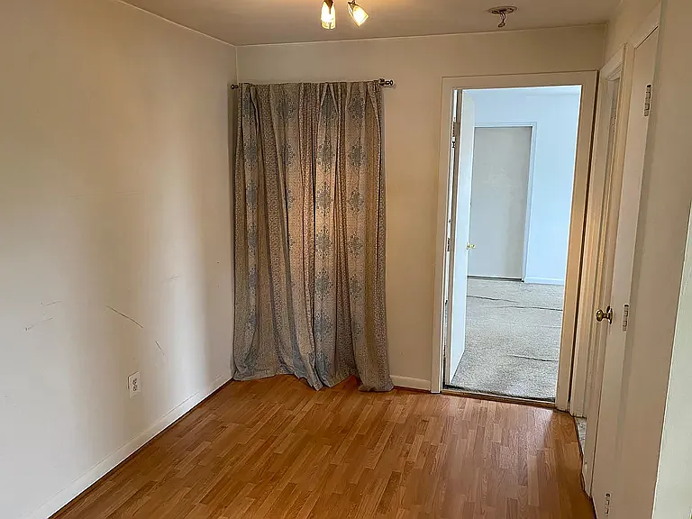 Entry/dining room. View into bedroom (laminate flooring has replaced carpet)