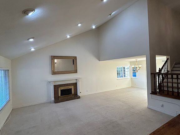 Living Room / Dining Room from Entry with cathedral ceiling and gas fireplace.