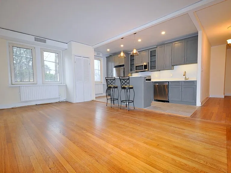 Large Living Room, with refinished hardwood floors, opens to the kitchen.