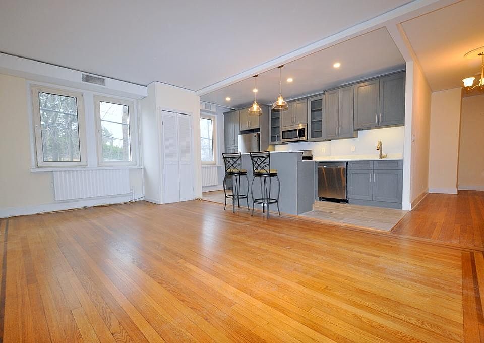Large Living Room, with refinished hardwood floors, opens to the kitchen.