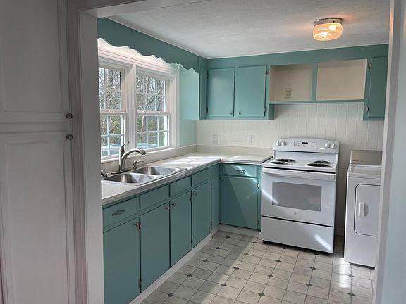 newly painted kitchen cabinets and new vinyl flooring.