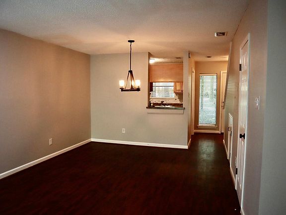 open concept living/dining area with pass through window to kitchen