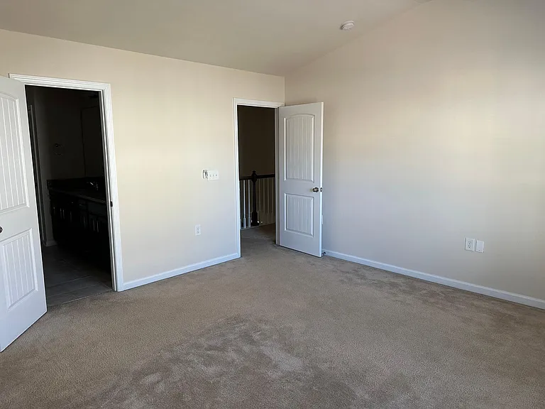 A view from the opposite corner within the main bedroom. To the left is the main bath and walk in closet.