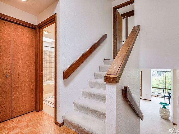 As you enter the front door, you can go down to the living area and kitchen or up the stairs to the master suite. Full bathroom on the left with the extra bedroom to the left of the bathroom.  