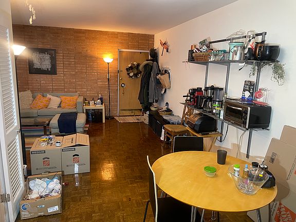 View of brick wall and entry to unit