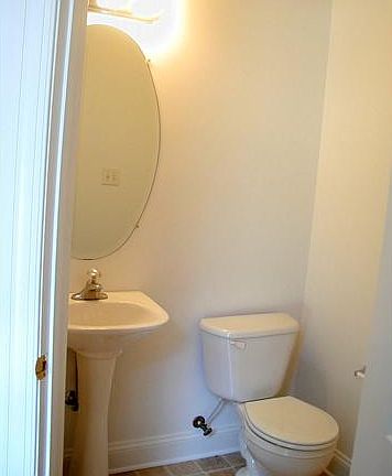 Powder room close to foyer with new flooring