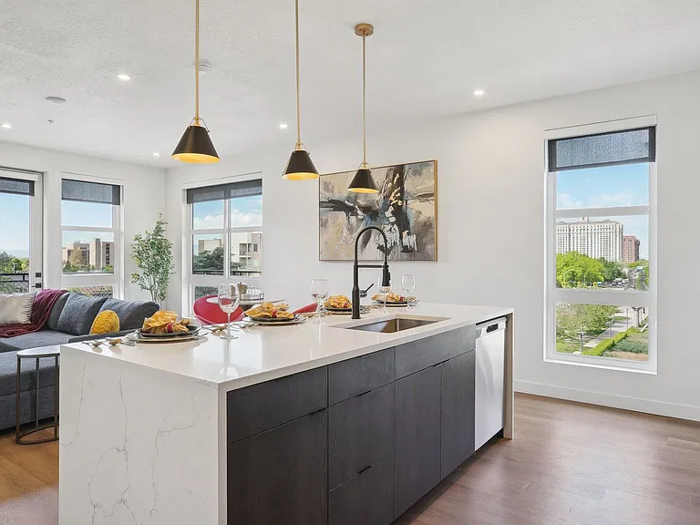 Liberty Duet Apartments, Salt Lake City, Utah; A modern kitchen with a large island and pendant lights.