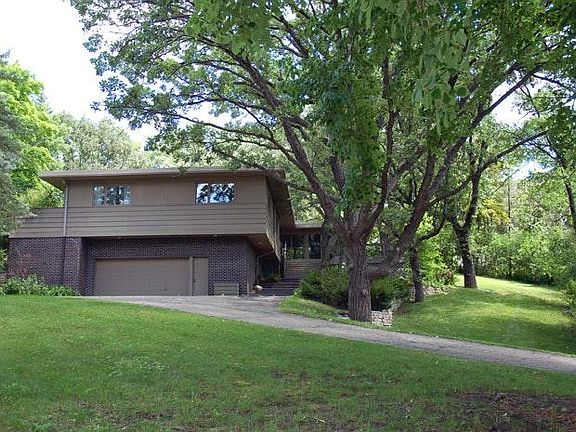 House has mature trees all around this half acre