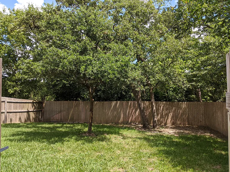 Very private and spacious yard with a covered awning over the back porch