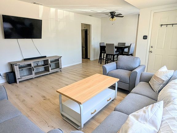 50" Smart TV, entertainment center and coffee table are provided.