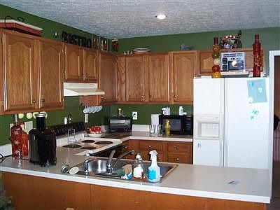 Lots of cabinet in this kitchen and a breakfast bar.