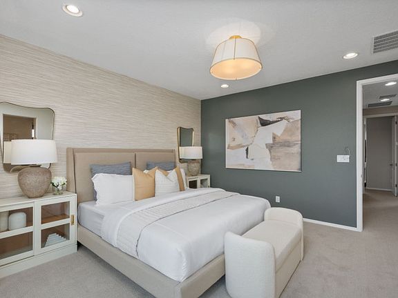 The owner s suite features a decorative accent wall, a spacious walk-in closet and owner s bath.