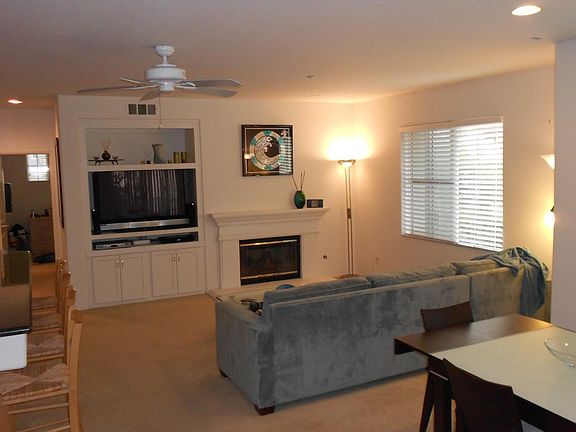 Great room w/fireplace, built-ins and dining area.