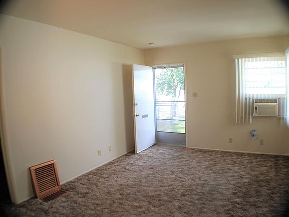 Living Room with Window A/C and Floor Furnace