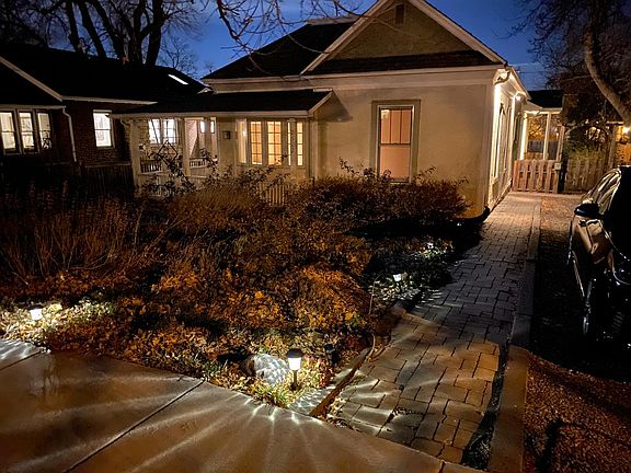 View from the street showing walkway down to the front porch, driveway on the side