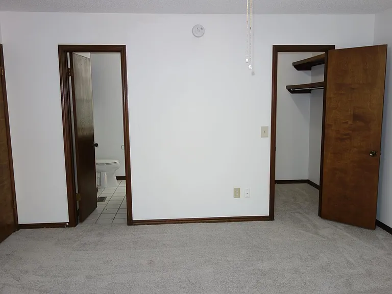 another 2nd bedroom view. Walk-in closet on right and bathroom access on left.