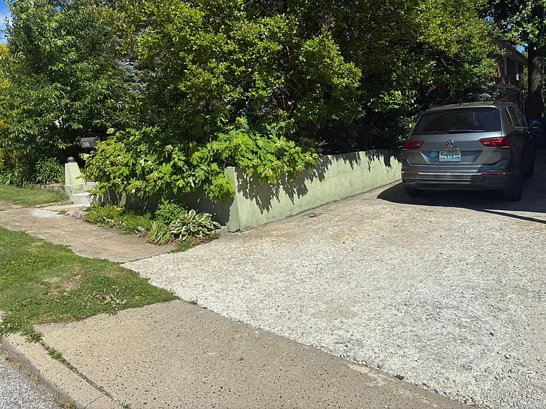 Driveway, fits two cars (one in front of other), plus easy street parking. Private entrance to lower level mother-in-law suite at end of driveway.