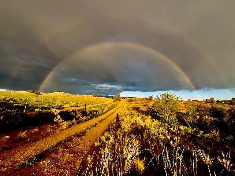 Magnifient wide open views during dramatic summer sky with full rain bow