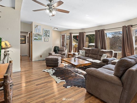 Sunny living space with view of the fully fenced back yard.