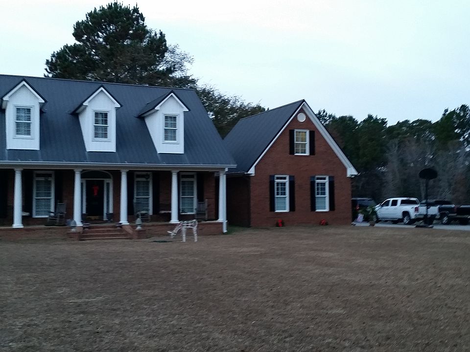 Front View of home with Pond