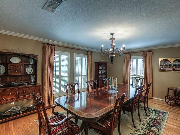 Formal dining has room for entertaining as well as family heirloom cabinets